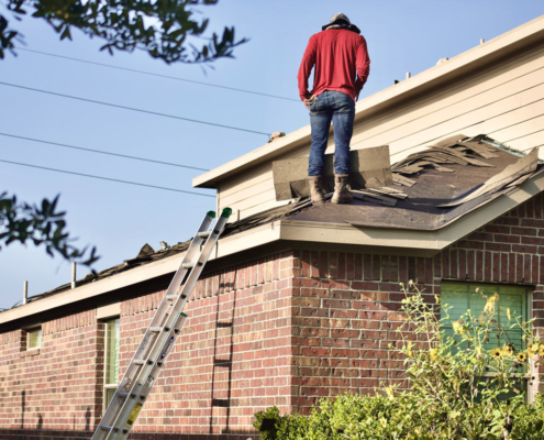 Man Inspecting a Roof